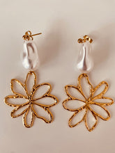 Load image into Gallery viewer, Turn heads with these romantic stainless steel and acrylic flower pearl earrings. Featuring an eye-catching, irregular artificial pearl as the focal point, these statement earrings are complemented by delicate flower contours that gracefully dangle below. A perfect blend of elegance and charm, they add a bold yet feminine touch to any outfit.