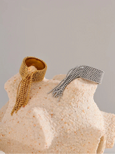 Load image into Gallery viewer, Make a bold statement with this stainless steel chain tassel finger ring, featuring an eye-catching adjustable design in both gold and silver 18K plated finishes. Crafted from high-quality stainless steel, this stylish ring combines elegance with modern charm. The delicate chain tassel detail adds a unique touch, making it a perfect accessory for any fashion-forward jewelry lover. Ideal for both casual and special occasions!