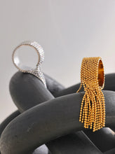 Load image into Gallery viewer, Make a bold statement with this stainless steel chain tassel finger ring, featuring an eye-catching adjustable design in both gold and silver 18K plated finishes. Crafted from high-quality stainless steel, this stylish ring combines elegance with modern charm. The delicate chain tassel detail adds a unique touch, making it a perfect accessory for any fashion-forward jewelry lover. Ideal for both casual and special occasions!