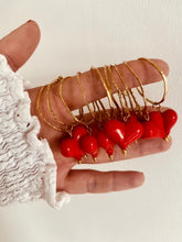 Load image into Gallery viewer, These handcrafted stainless steel earrings showcase a distinctive, irregular hollow circle that hangs gracefully above a vibrant acrylic heart, available in bold red or soft white. The heart dangles elegantly below the circle, creating a playful yet modern contrast that adds a touch of color and movement to any look. Lightweight, durable, and full of personality, these earrings combine geometric precision with artistic flair, making them the perfect accessory to elevate your style for any occasion.
