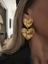 Load image into Gallery viewer, Add a subtle romantic touch to your everyday look with these textured heart drop earrings, designed in a clean and minimalist style. Crafted from durable stainless steel with an 18k gold color plated finish, they offer a refined texture that catches the light beautifully. Hypoallergenic and comfortable for daily wear, these earrings are perfect for women who love modern, understated jewelry with a timeless charm.
