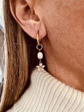 Load image into Gallery viewer, Elevate your style with these pearl flower zircon tassel earrings, designed to add graceful charm to any outfit. Crafted from durable stainless steel with a luxurious PVD gold-plated finish, they feature a delicate pearl flower accented with sparkling zircon stones and elegant tassel details. Fashionable yet timeless, these earrings are lightweight, comfortable to wear, and make a perfect gift for women who love refined, eye-catching jewelry.
