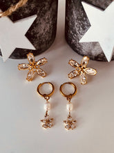 Load image into Gallery viewer, Elevate your style with these pearl flower zircon tassel earrings, designed to add graceful charm to any outfit. Crafted from durable stainless steel with a luxurious PVD gold-plated finish, they feature a delicate pearl flower accented with sparkling zircon stones and elegant tassel details. Fashionable yet timeless, these earrings are lightweight, comfortable to wear, and make a perfect gift for women who love refined, eye-catching jewelry.
