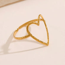 Load image into Gallery viewer, Fall in love with the effortless charm of this stainless steel hollow heart ring — a minimalistic statement piece with a romantic twist. Featuring a sleek open design and a delicate heart-shaped cutout, this ring blends Western-inspired style with modern simplicity. Available in both polished silver and radiant gold finishes, it's the perfect accessory for adding a subtle touch of elegance to your everyday look or party outfit. Durable, waterproof, and endlessly versatile, it also makes a thoughtful gift th
