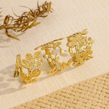 Load image into Gallery viewer, Add a touch of nature’s elegance to your look with this exquisite stainless steel metal plants ring. Featuring a beautifully irregular texture and 18K gold plating, this ring combines organic, leaf-inspired design with a modern, luxurious twist. The intricate metalwork captures the beauty of nature while remaining trendy and wearable for any occasion. Waterproof and crafted for durability, this statement piece is perfect for those who appreciate bold style with a timeless, sophisticated charm. A must-have f
